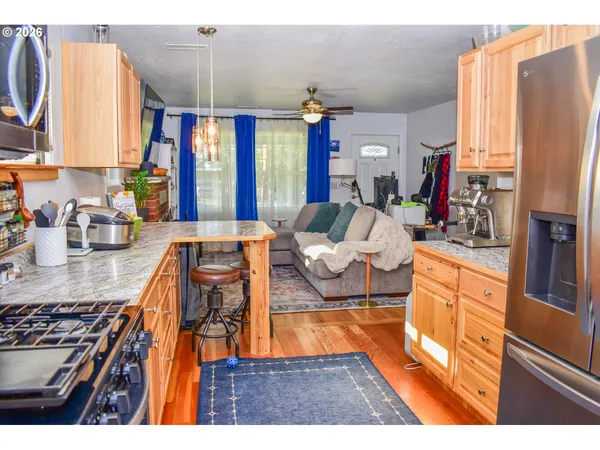 a living room with large window and wooden floor