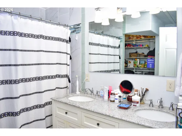 a bathroom with a granite countertop sink and a mirror