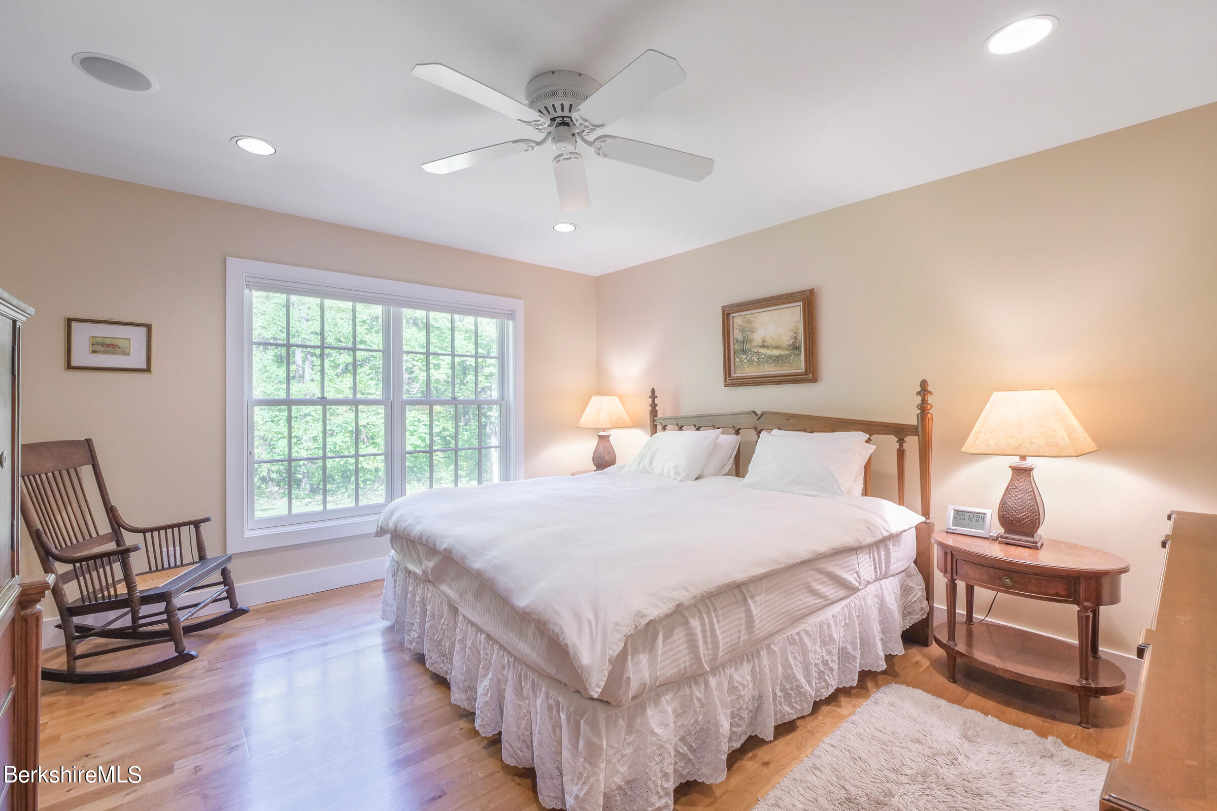 67 Fairview Road Monterey, MA 01245 - Photo 16 of 27 a bedroom with a bed a lamp and a large window