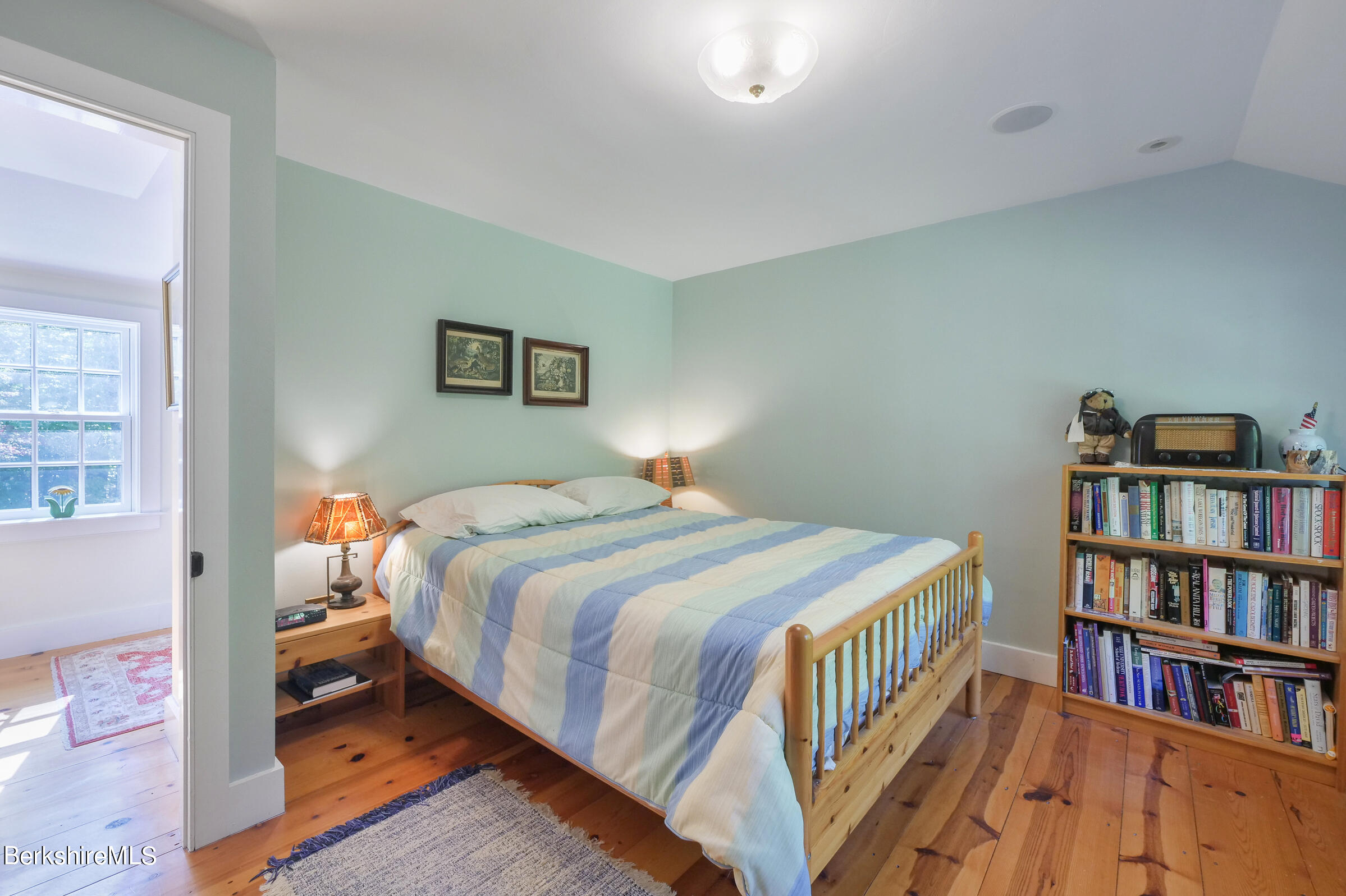 67 Fairview Road Monterey, MA 01245 - Photo 18 of 27 a bedroom with a bed and a book shelf