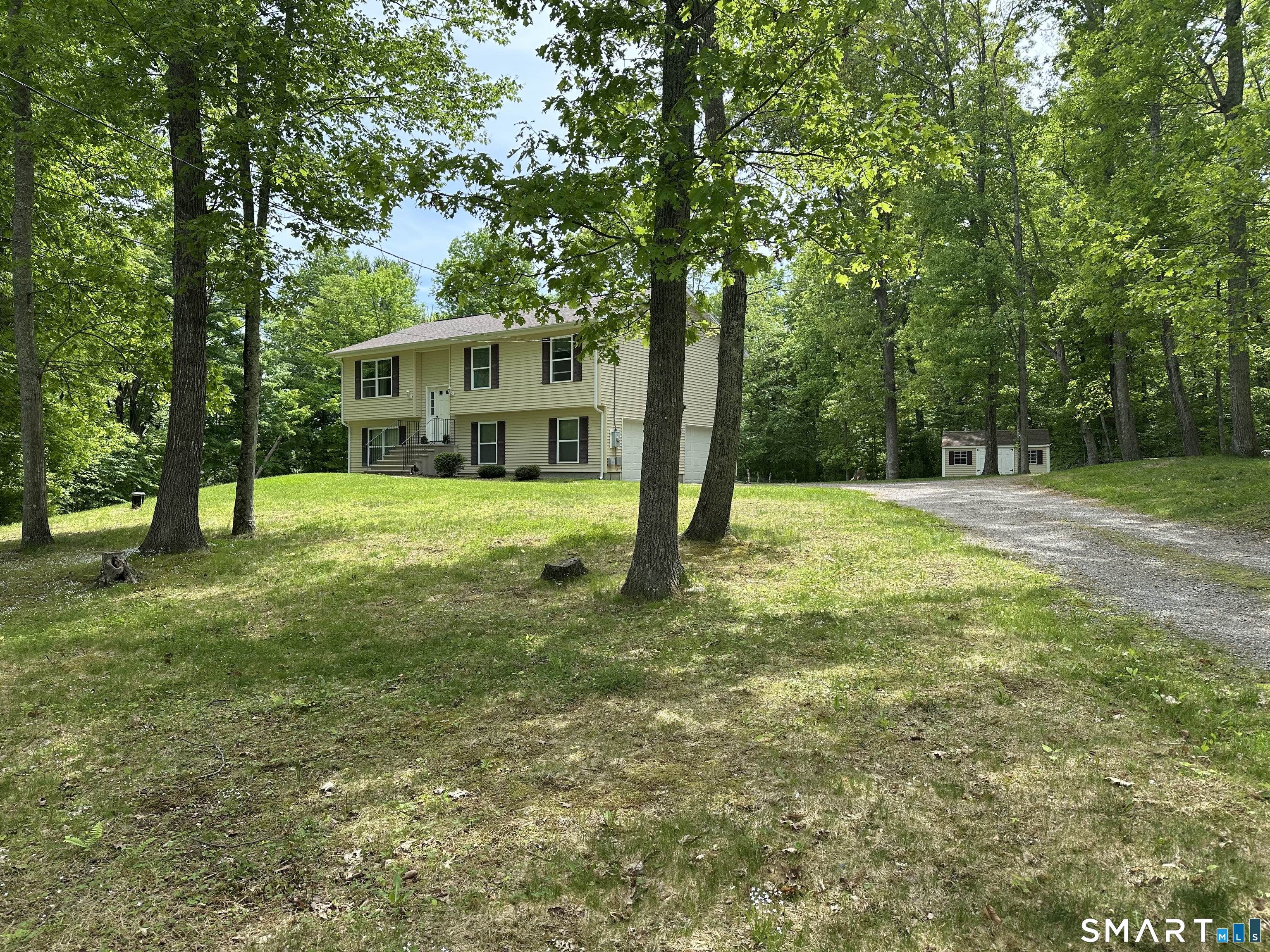 116 Tatnic Hill Road Brooklyn, CT 06234 - Photo 3 of 27 a view of a house with a big yard and large trees