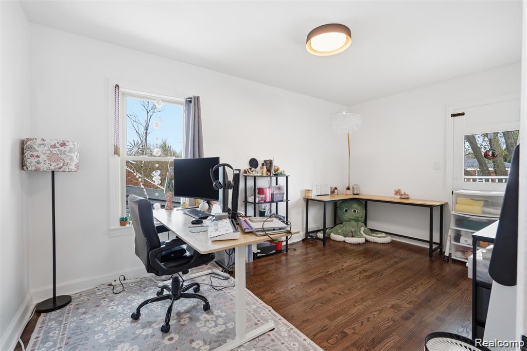 4612 Balfour Road Detroit, MI 48224 - Photo 14 of 20 Bright room featuring rich wood flooring, white walls, a window with natural light, a ceiling-mounted light fixture, and a door