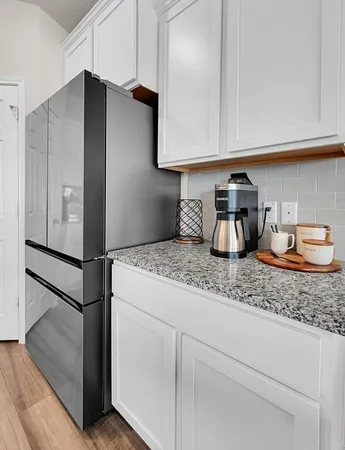 a kitchen with stainless steel appliances granite countertop a refrigerator and a sink