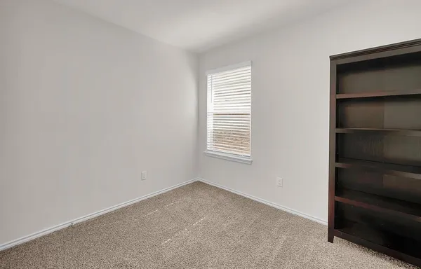 a view of an empty room with a closet