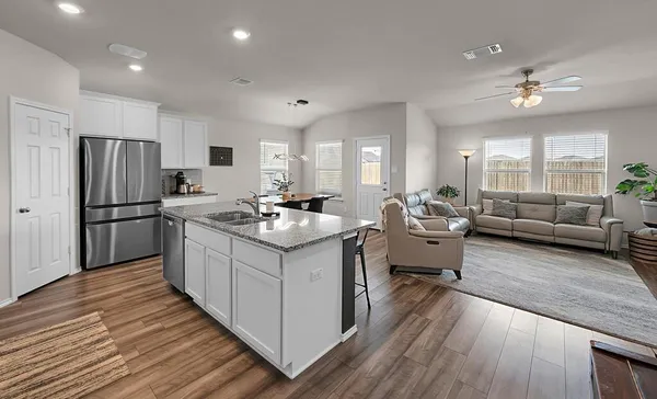 a kitchen with sink refrigerator and windows