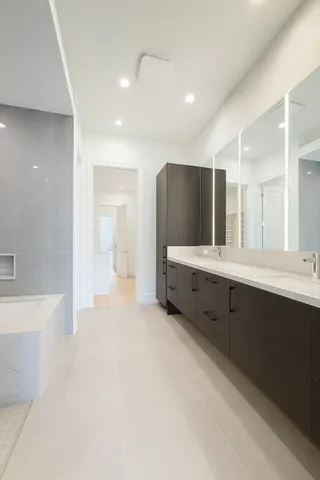 a bathroom with a double vanity sink and mirror