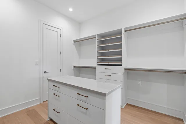 a view of walk in closet with empty racks