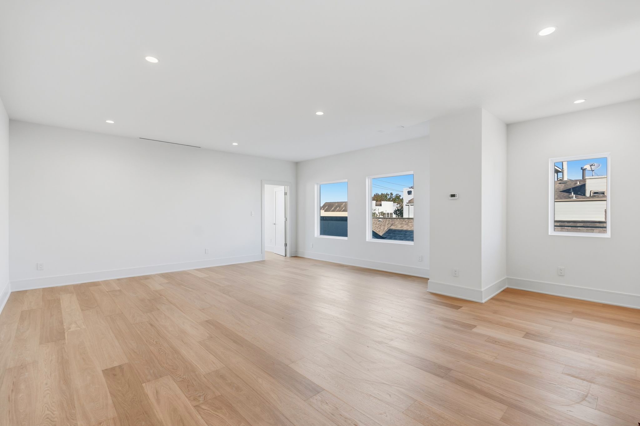 820 Malone Street Houston, TX 77007 - Photo 24 of 31 a view of an empty room with wooden floor and a window