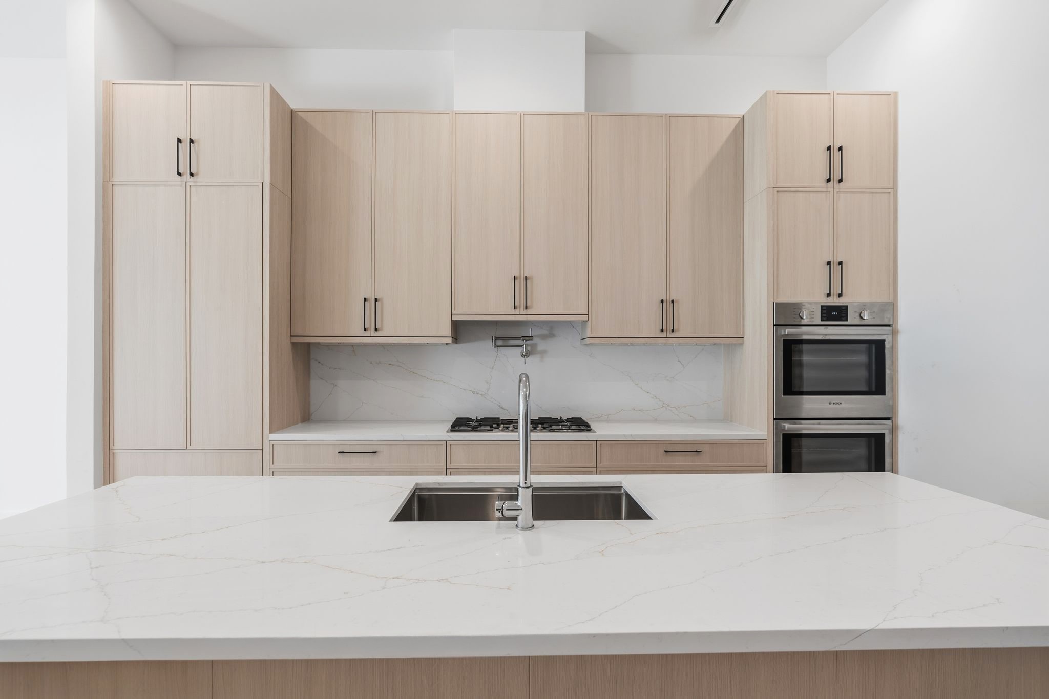 820 Malone Street Houston, TX 77007 - Photo 5 of 31 Bosch appliance suite includes double ovens, 36" gas cooktop with pot filler, and 36" integrated refrigerator.