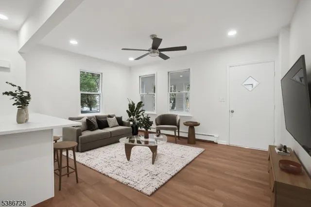 a bedroom with a large bed and a potted plant