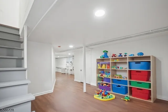 a view of a workspace with furniture and wooden floor