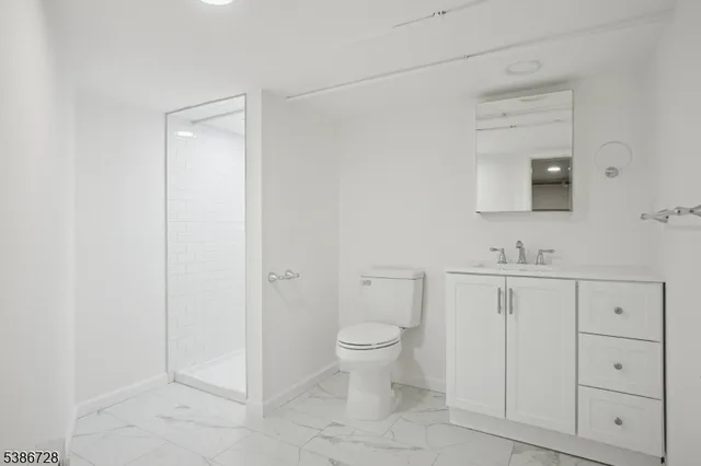 a view of a livingroom with furniture wooden floor front door and windows