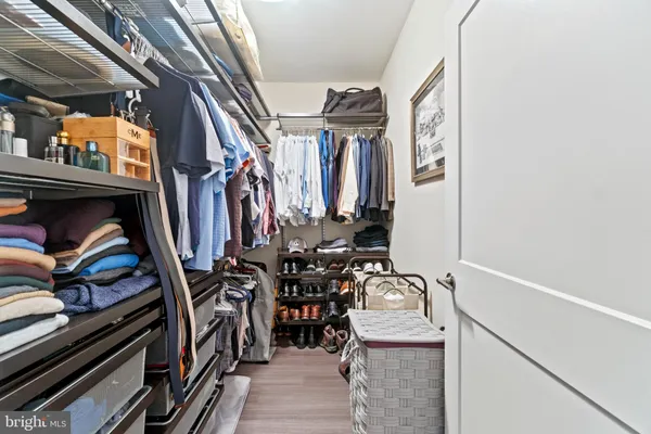 a view of walk in closet with clothes