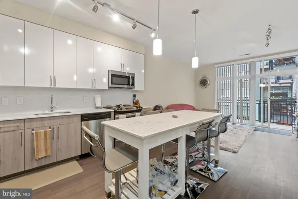 a kitchen with kitchen island a sink table and chairs