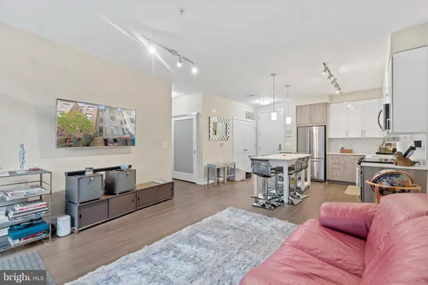a living room with furniture and kitchen view
