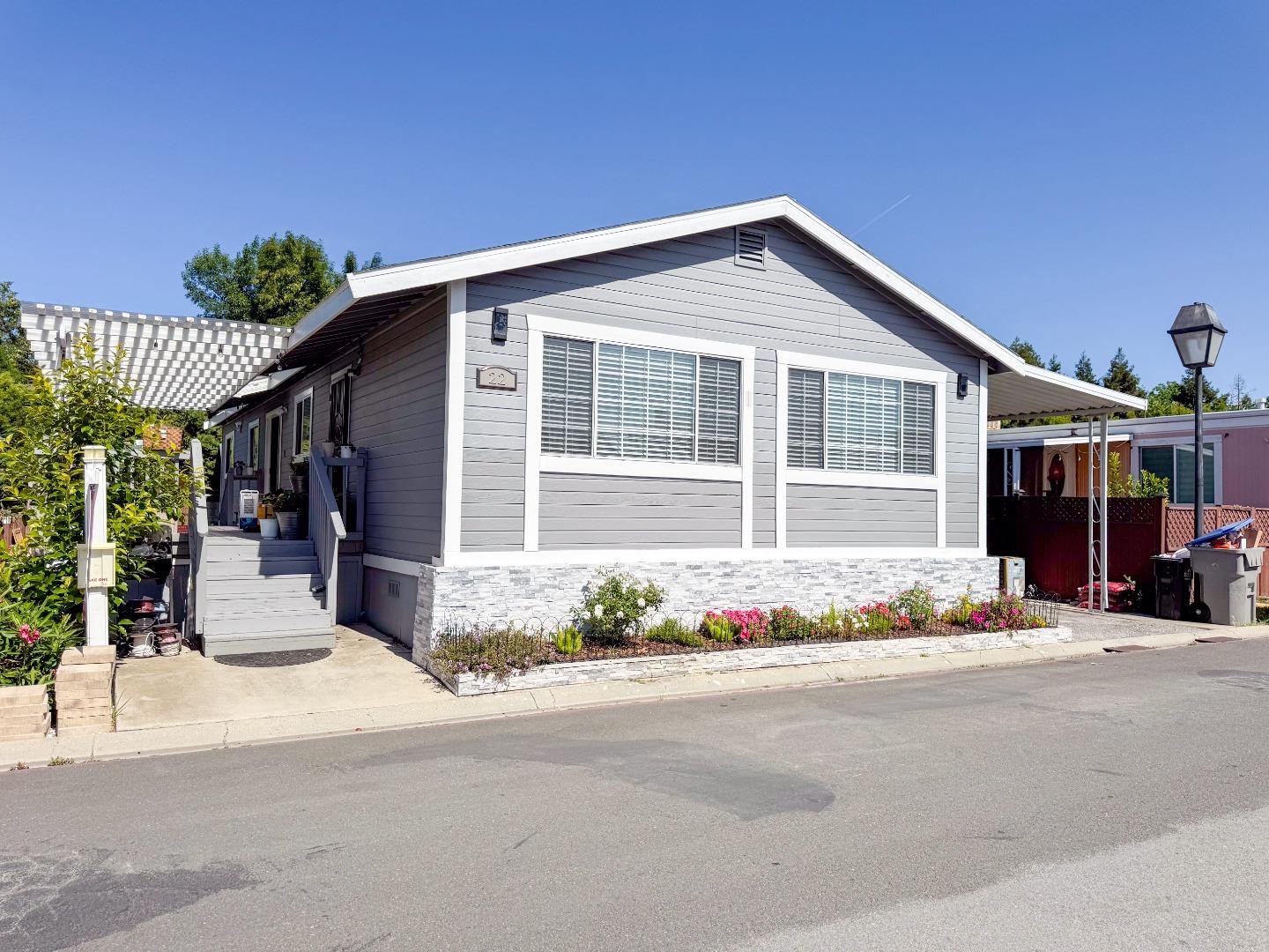 6130 Monterey Road, Unit 22 San Jose, CA 95138 - Photo 1 of 21 a front view of a house with a garden and yard