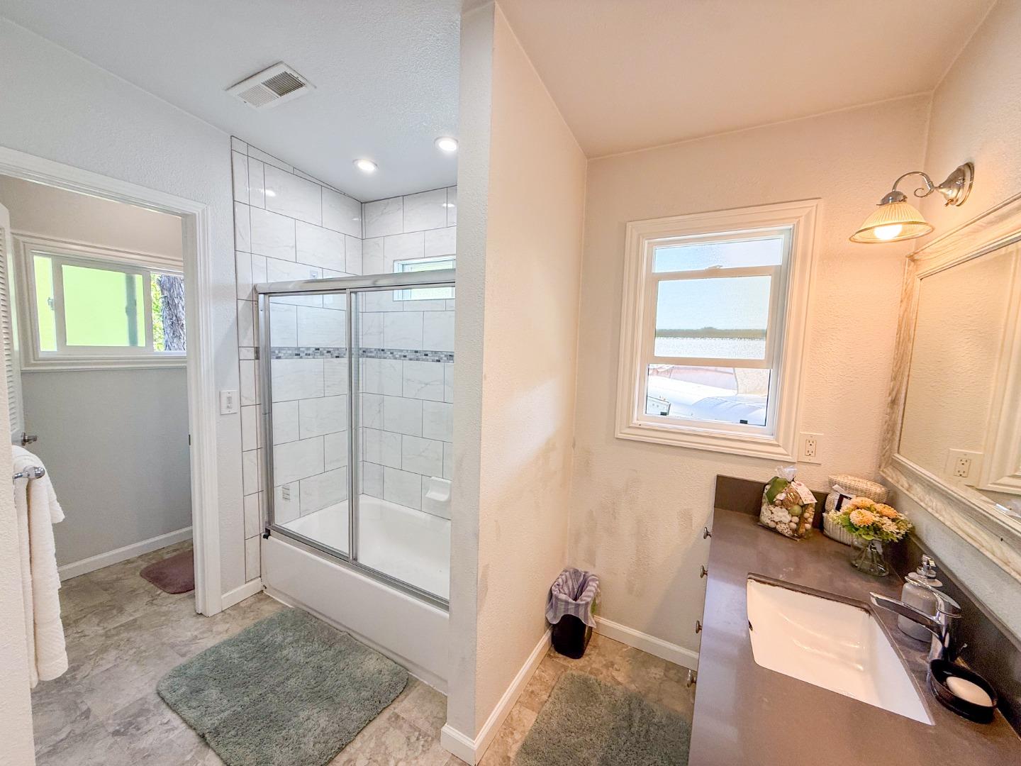 6130 Monterey Road, Unit 22 San Jose, CA 95138 - Photo 11 of 21 a bathroom with a granite countertop sink and a mirror