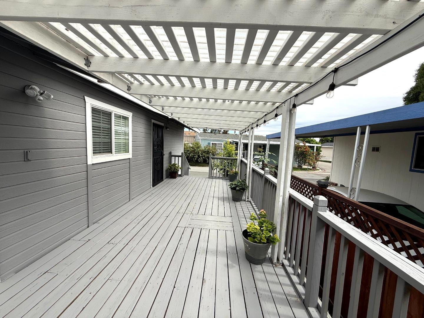 6130 Monterey Road, Unit 22 San Jose, CA 95138 - Photo 15 of 21 a view of balcony with wooden floor and fence