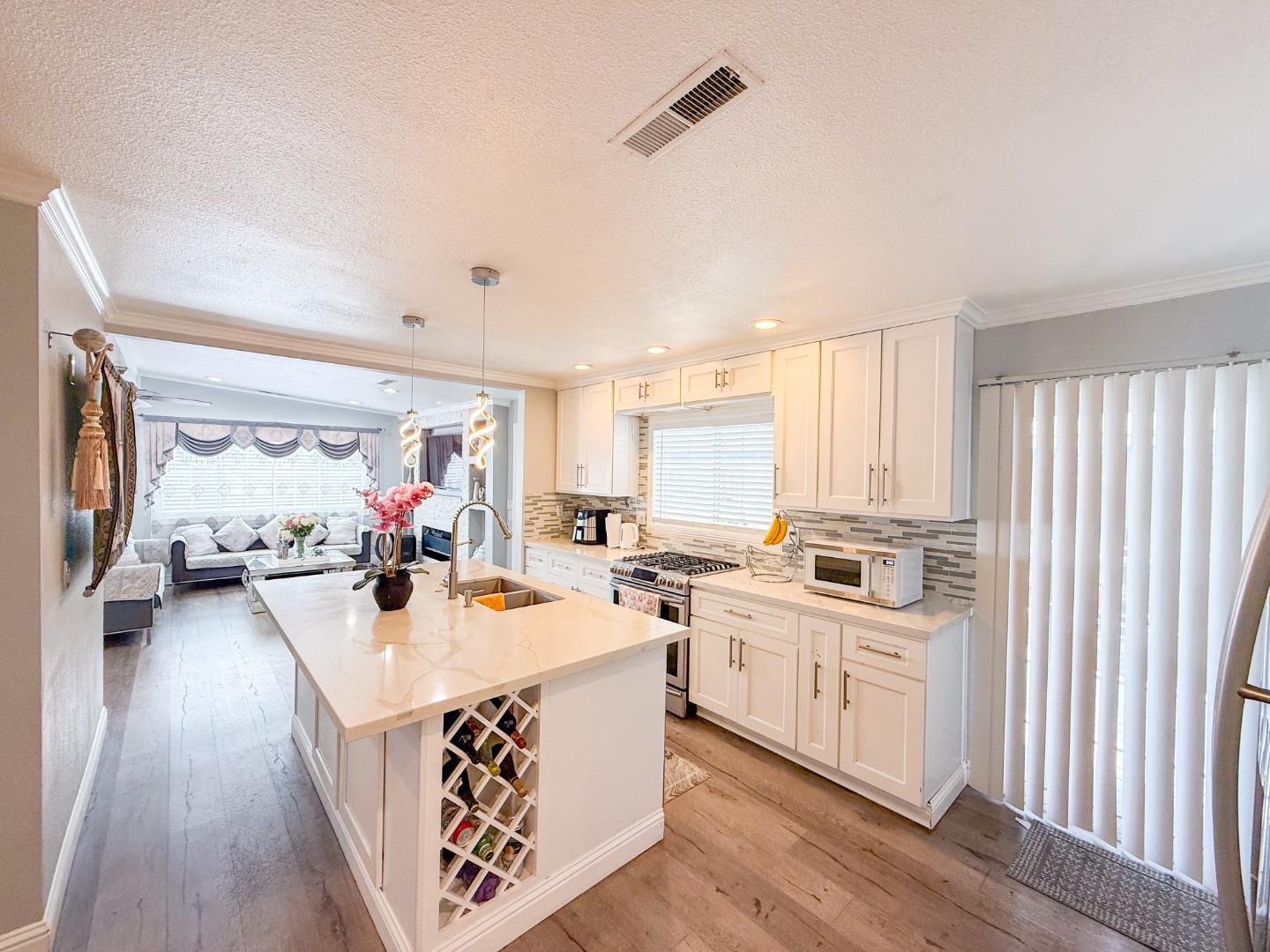 6130 Monterey Road, Unit 22 San Jose, CA 95138 - Photo 4 of 21 a large kitchen with sink a refrigerator and wooden floor