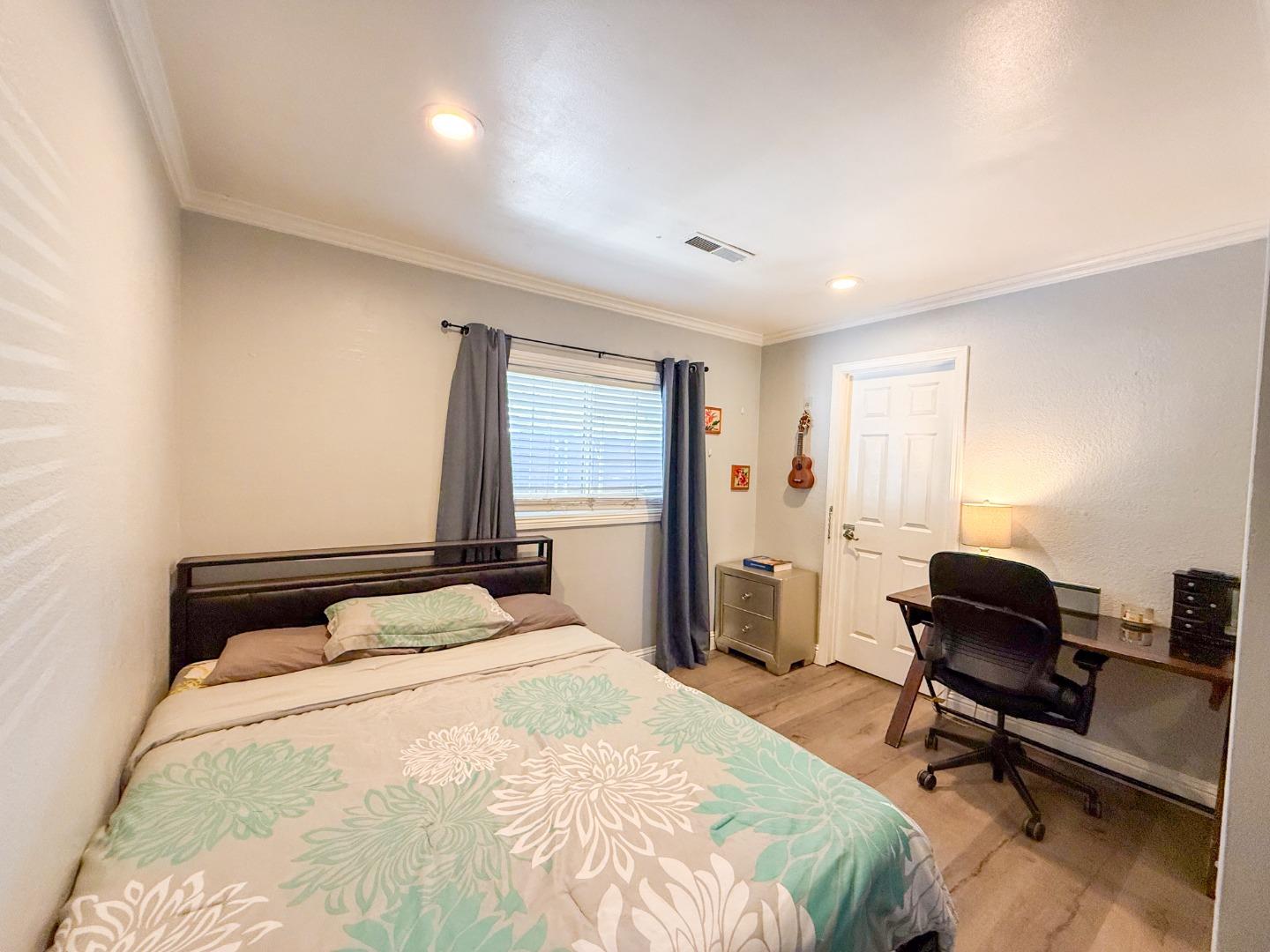6130 Monterey Road, Unit 22 San Jose, CA 95138 - Photo 7 of 21 a bedroom with a bed a chair and a large window