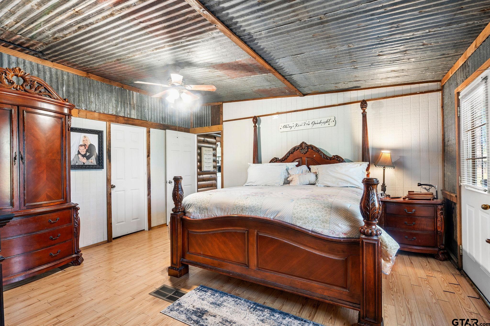 4550 Crabapple Road Gilmer, TX 75645 - Photo 12 of 33 a bedroom with a bed and wooden floor