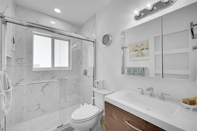 a bathroom with a sink toilet and shower