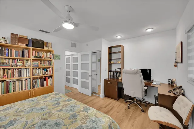 a view of a workspace with furniture and a bookshelf