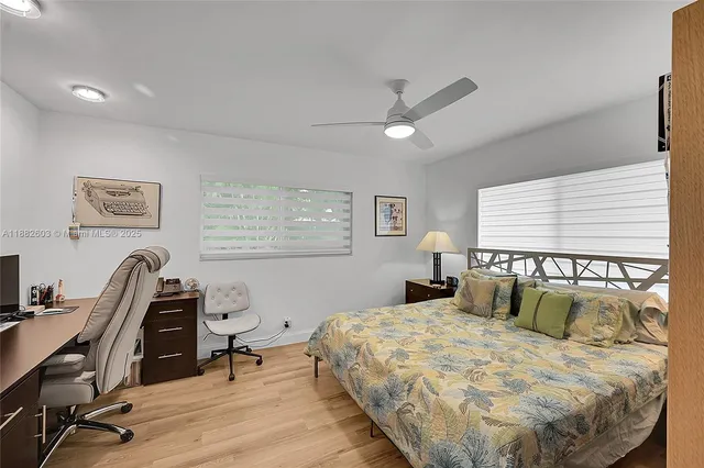 a bedroom with a bed a desk and chair