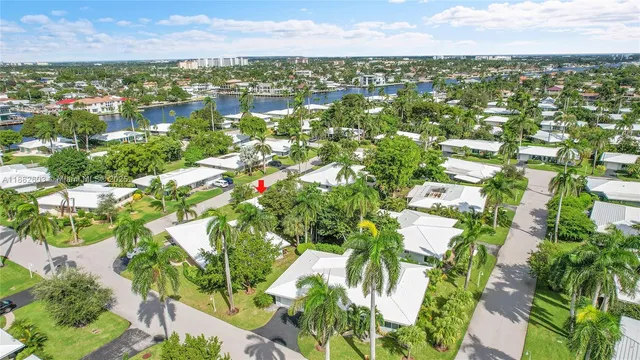 an aerial view of a house with a yard and lake view