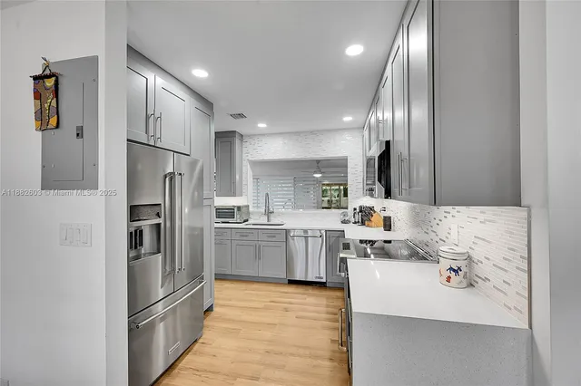 a kitchen with refrigerator and cabinets