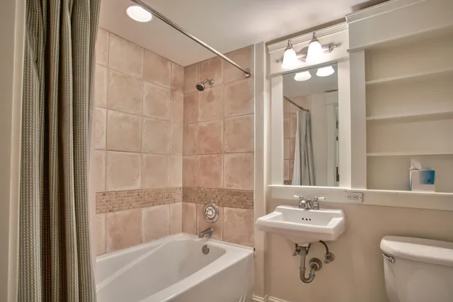 a bathroom with a sink mirror toilet and bathtub