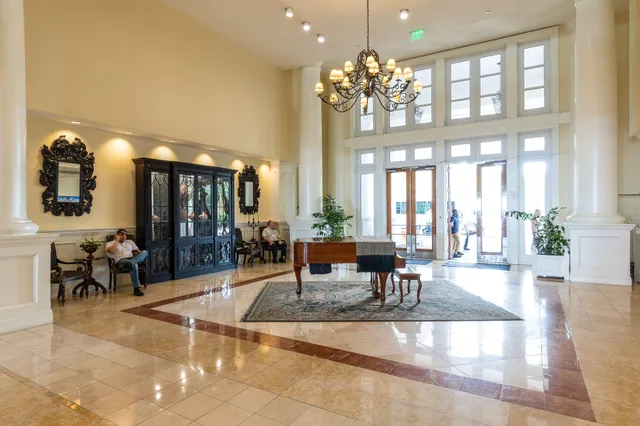 a lobby with furniture and a large mirror