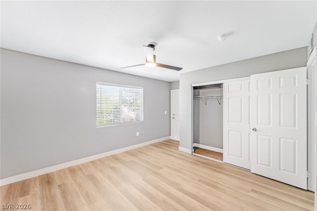 3318 North Decatur Boulevard, Unit 2152 Las Vegas, NV 89130 - Photo 17 of 58 A pristine bedroom showcasing durable wood flooring and ample closet space, ready for personalization.