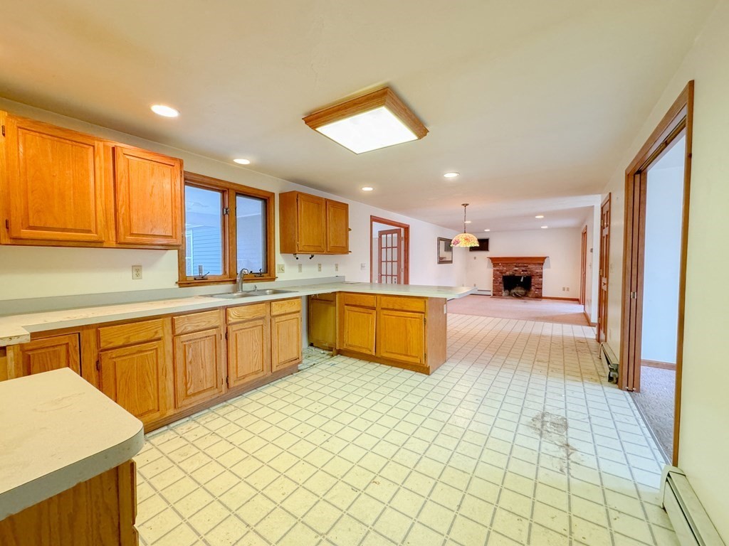 29 Thurston Hill Road Rutland, MA 01543 - Photo 24 of 38 a large kitchen with stainless steel appliances kitchen island granite countertop a refrigerator and a sink