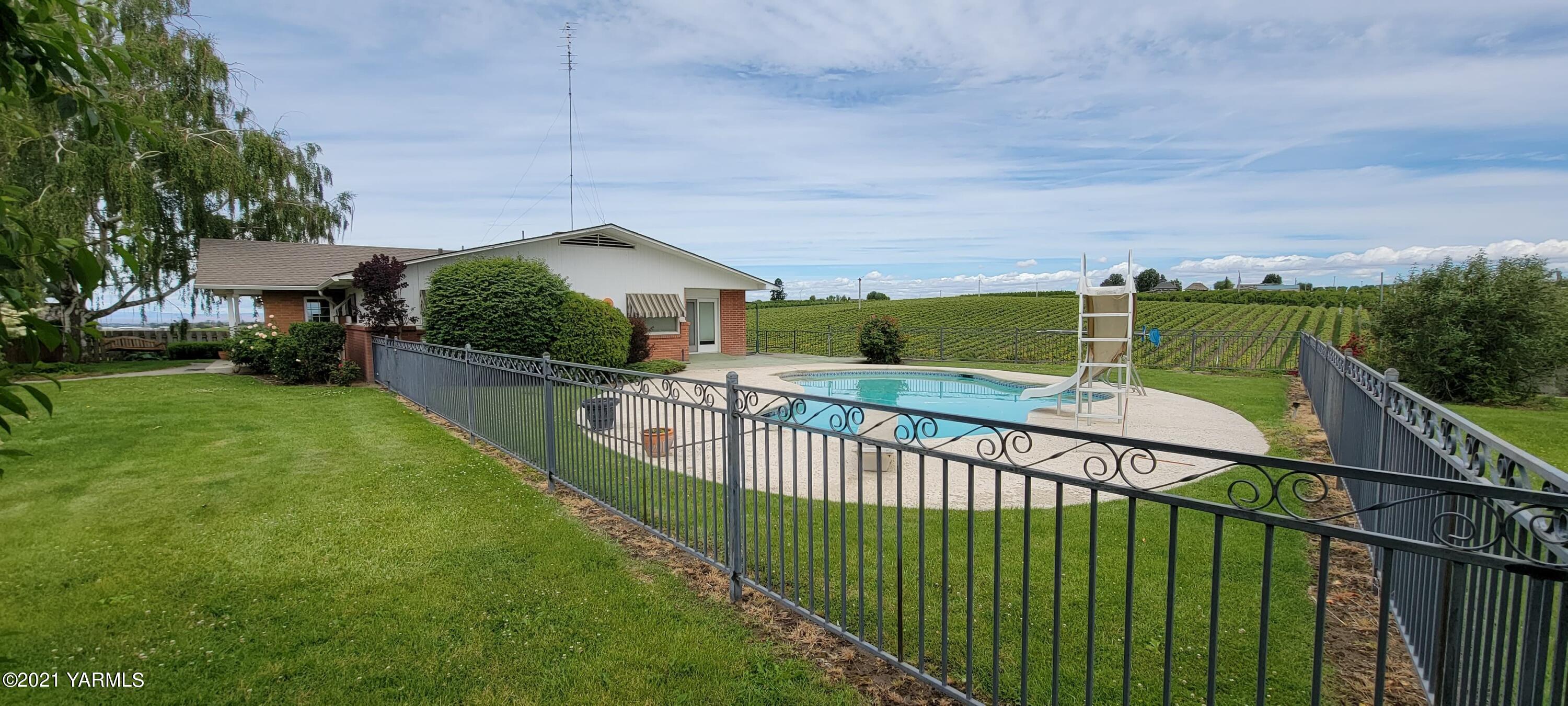 280 Tuttle Road Grandview, WA 98930 - Photo 1 of 8 a view of a wrought iron fences in front of house
