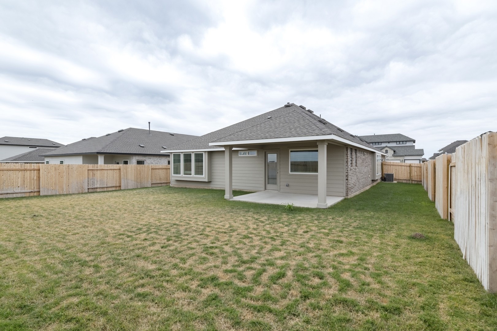 3729 Pin Oak Hills Seguin, TX 78155 - Photo 20 of 22 Back of property with a patio, a fenced backyard, and roof with shingles
