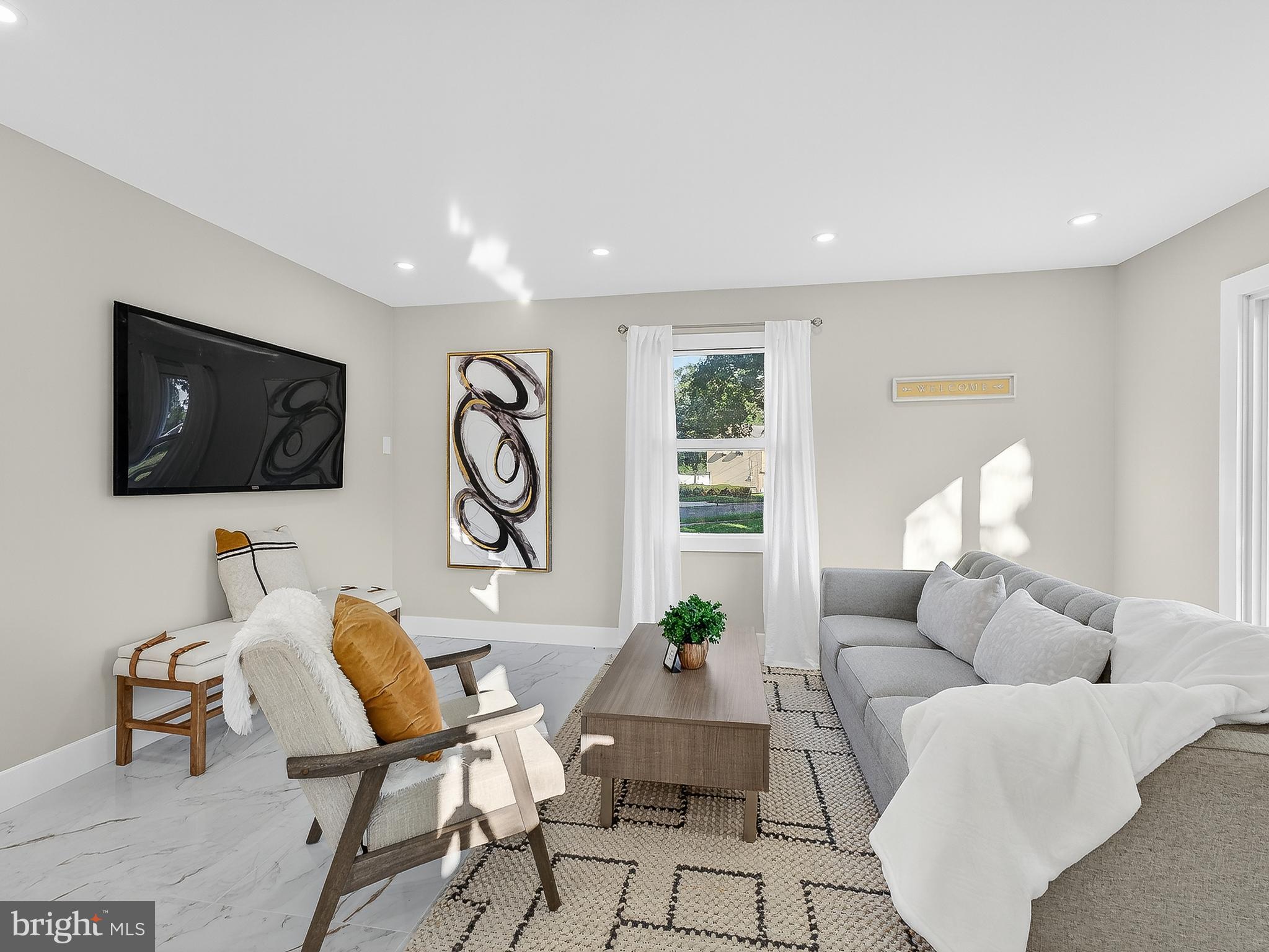 16 Estate Road Pemberton, NJ 08068 - Photo 16 of 40 a living room with furniture a flat screen tv and a large window