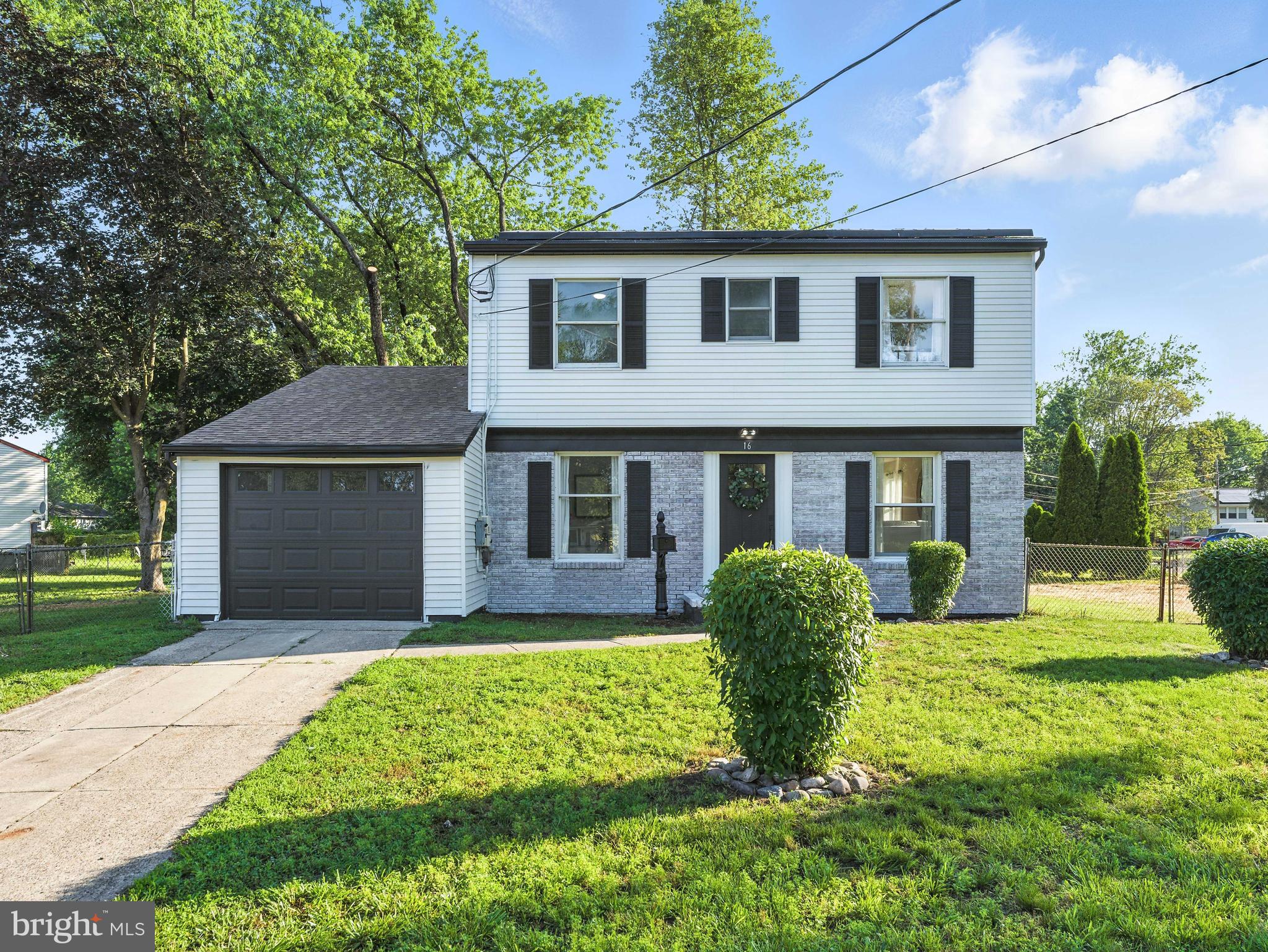 16 Estate Road Pemberton, NJ 08068 - Photo 2 of 40 a front view of a house with garden and yard
