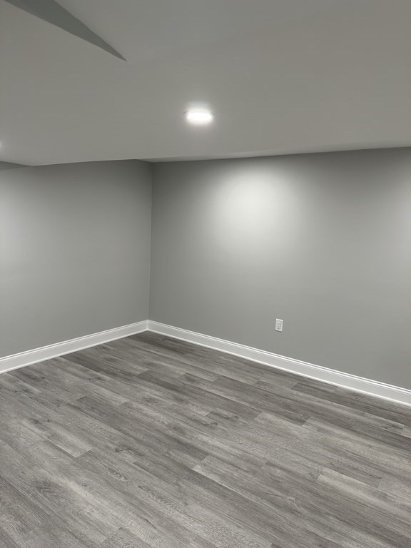 102 Beaconsfield Road Worcester, MA 01602 - Photo 7 of 34 an empty room with wooden floor and windows