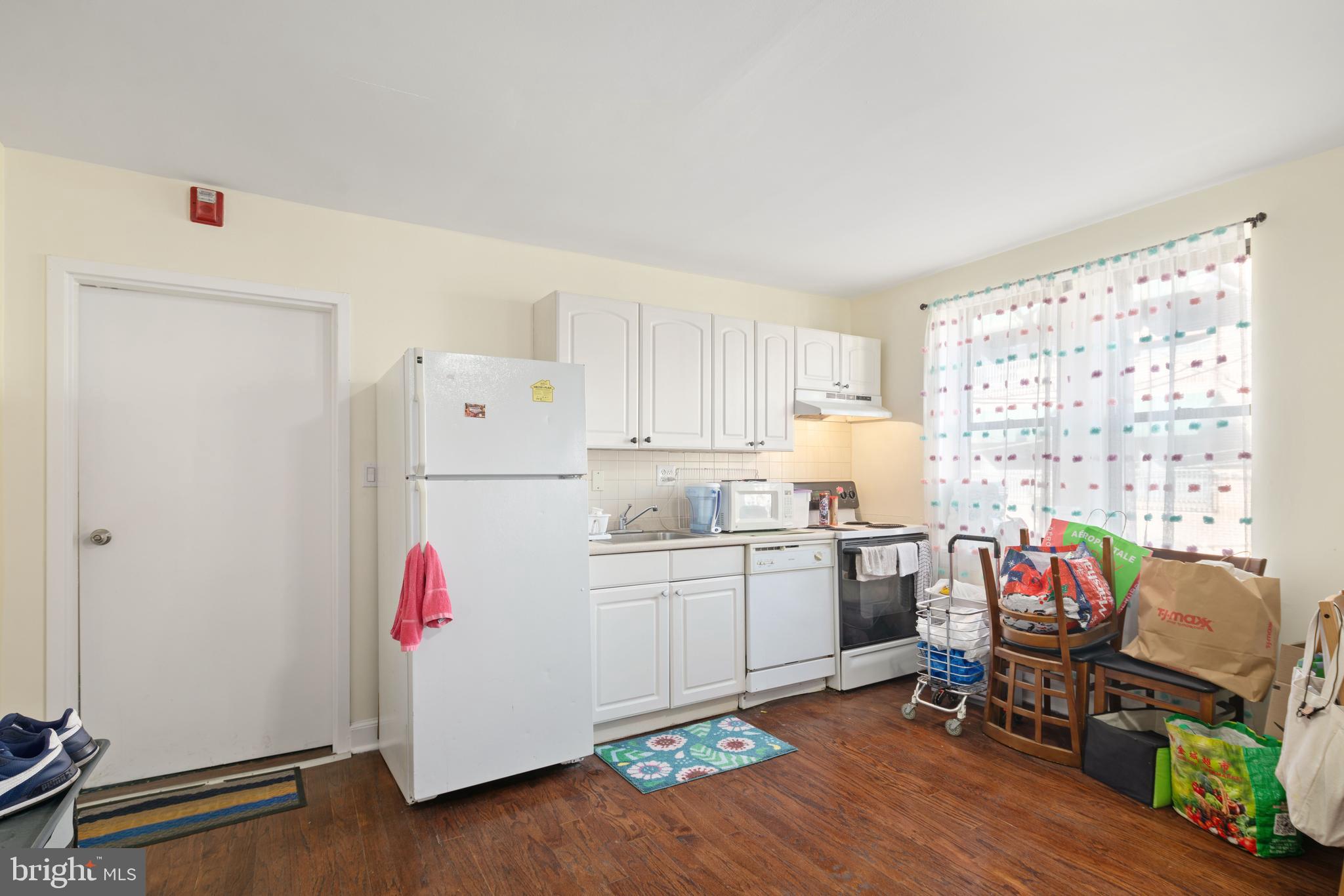 252 South Street, Unit 2 Philadelphia, PA 19147 - Photo 1 of 15 a kitchen with a refrigerator and wooden floor
