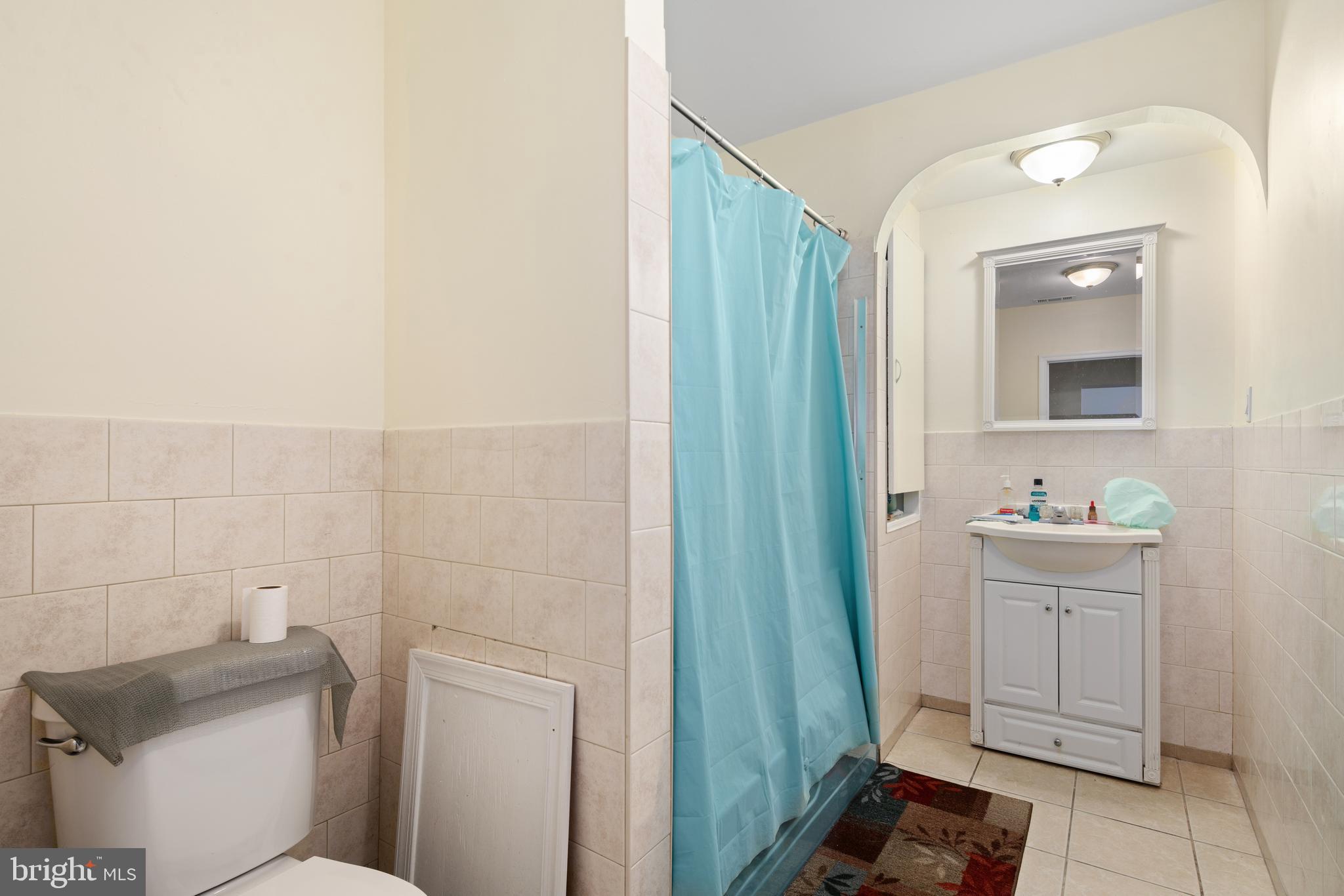 252 South Street, Unit 2 Philadelphia, PA 19147 - Photo 6 of 15 a bathroom with a toilet a sink a vanity and mirror