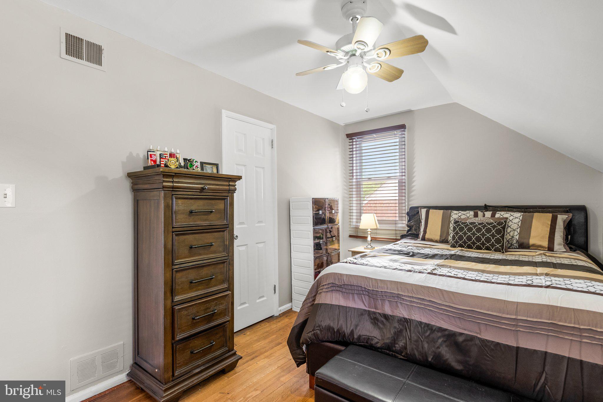 1013 Carson Street Silver Spring, MD 20901 - Photo 16 of 20 a bedroom with a bed and a chandelier