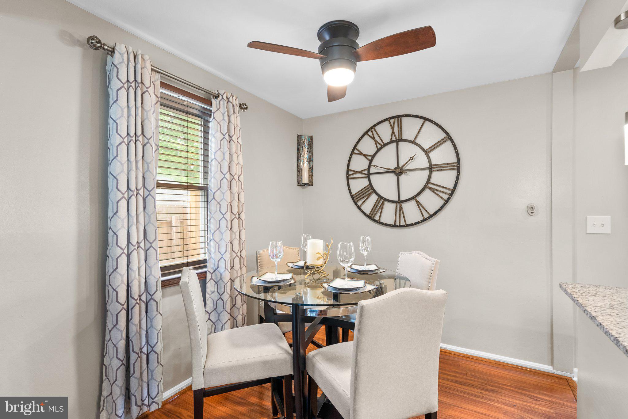 1013 Carson Street Silver Spring, MD 20901 - Photo 7 of 20 a dining room with wooden floor a chandelier a wooden table and chairs