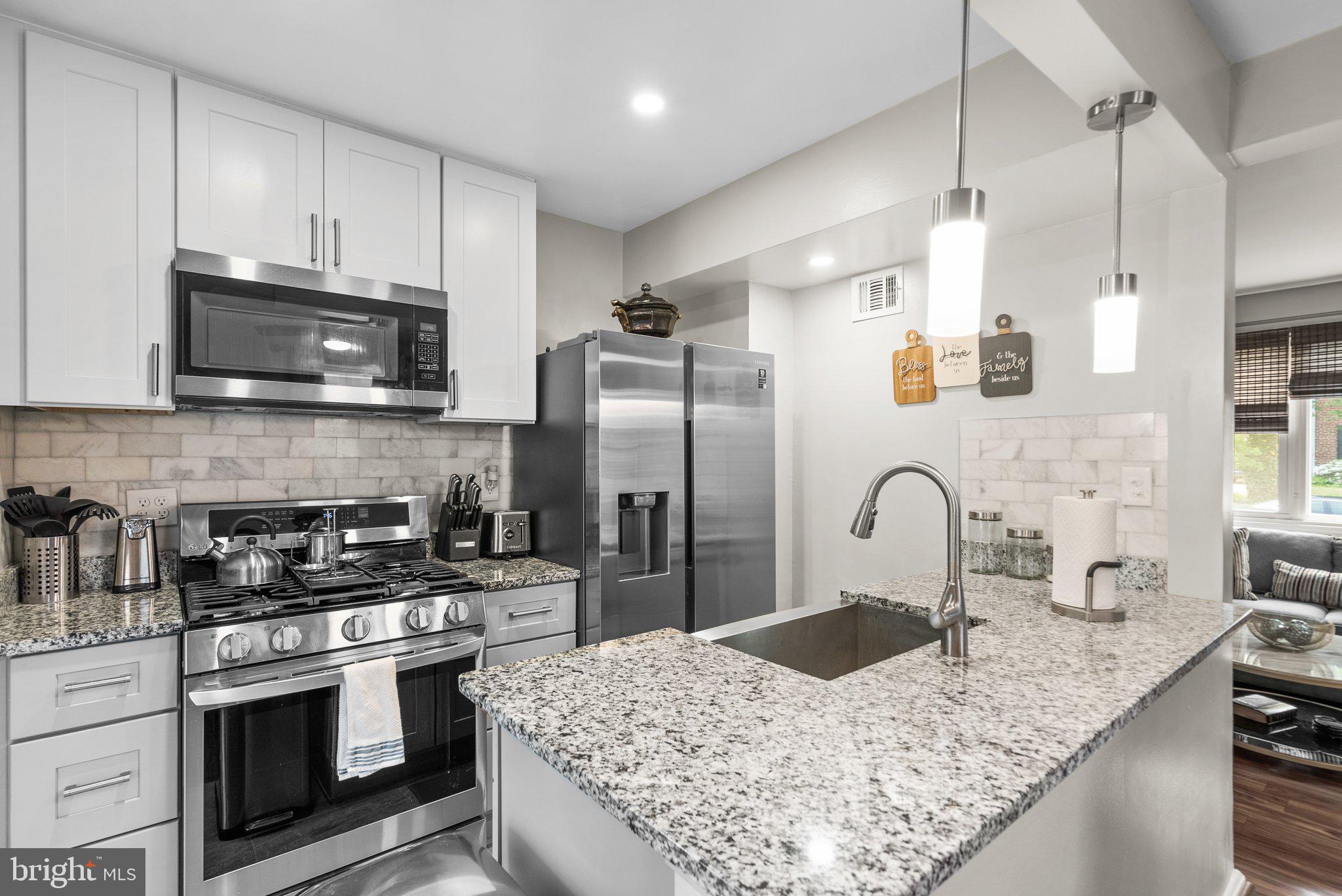 1013 Carson Street Silver Spring, MD 20901 - Photo 8 of 20 a kitchen with stainless steel appliances granite countertop a sink a stove a refrigerator and cabinets