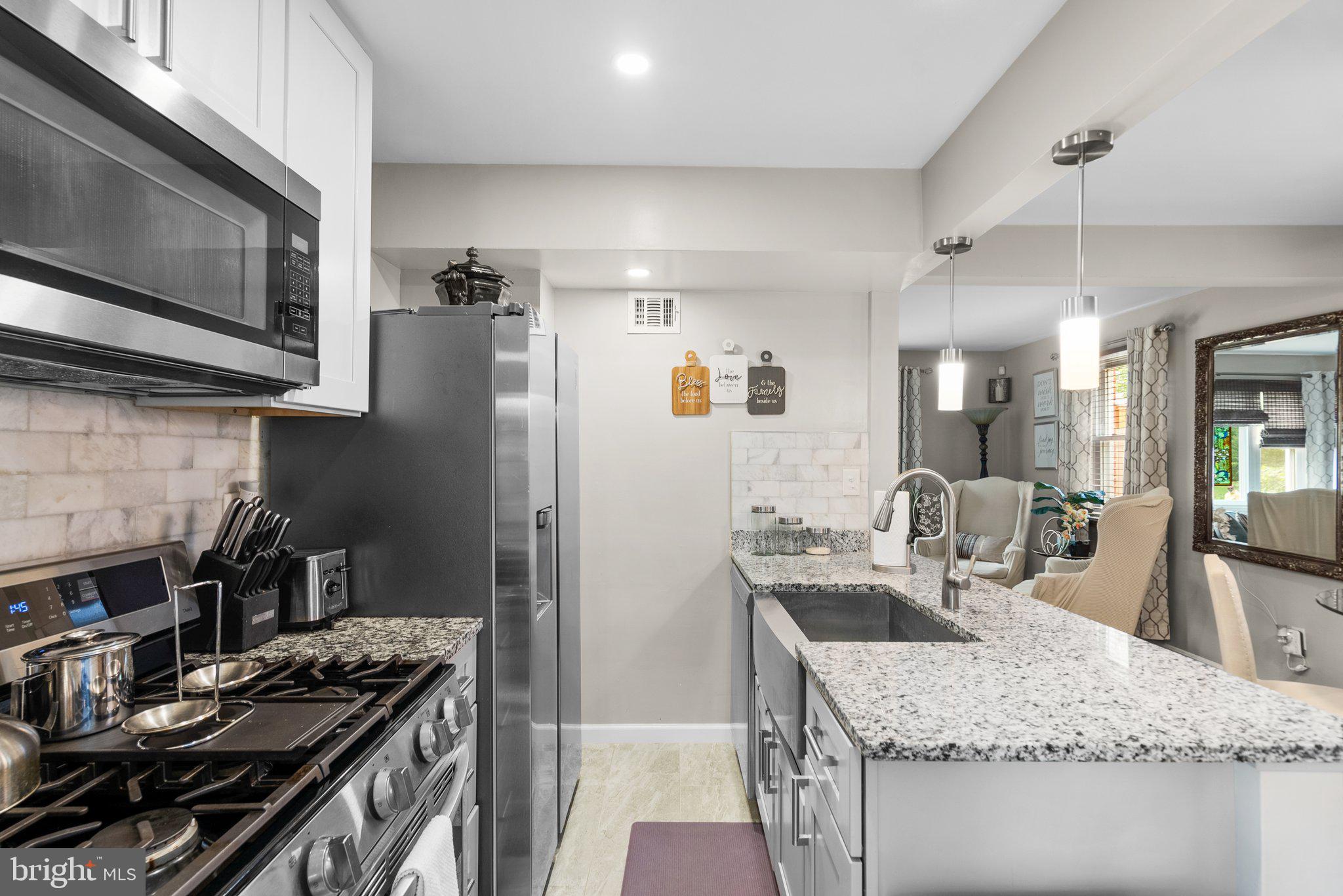 1013 Carson Street Silver Spring, MD 20901 - Photo 9 of 20 a kitchen with stainless steel appliances granite countertop a sink stove and refrigerator