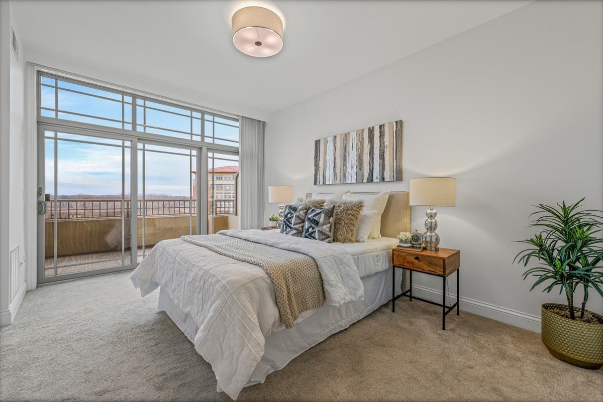 45 Prairie Park Drive, Unit 501 Wheeling, IL 60090 - Photo 13 of 30 a spacious bedroom with a bed and a large window