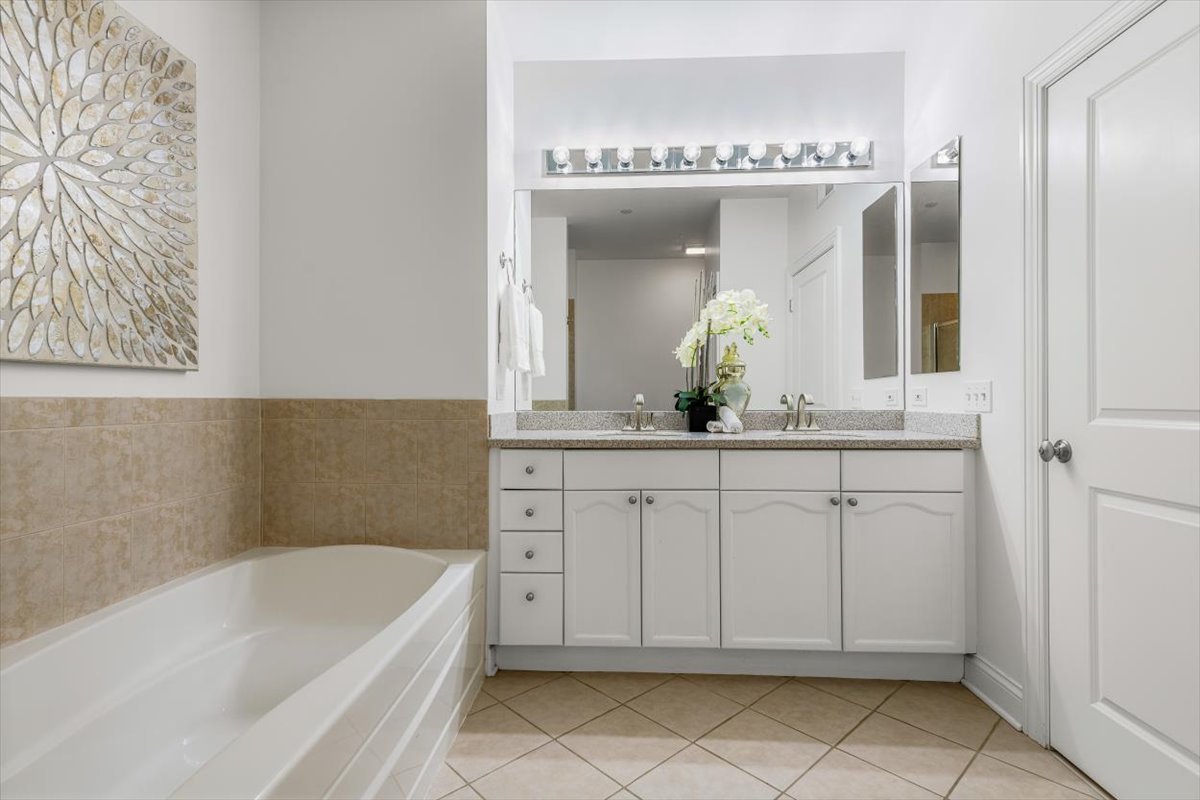45 Prairie Park Drive, Unit 501 Wheeling, IL 60090 - Photo 15 of 30 a bathroom with a double vanity sink mirror and bathtub