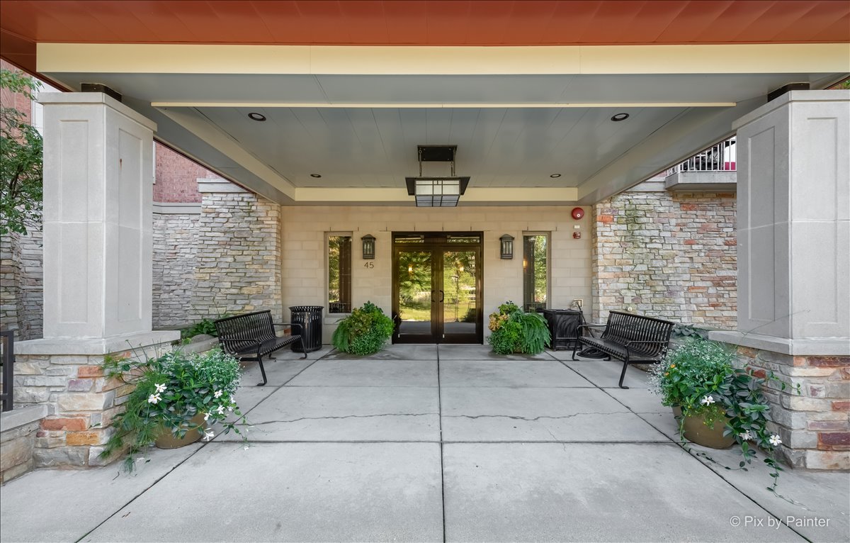 45 Prairie Park Drive, Unit 501 Wheeling, IL 60090 - Photo 2 of 30 a front view of a house with potted plants