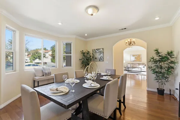 a view of a dining room with furniture window and wooden floor