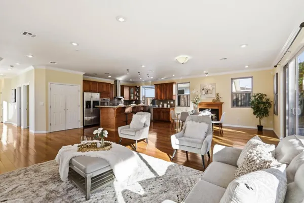 a living room with lots of furniture and view of kitchen